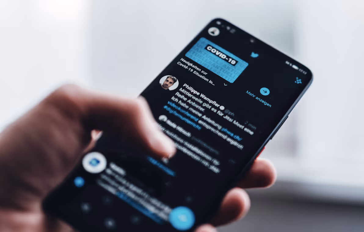 Image of a phone using Twitter (X)