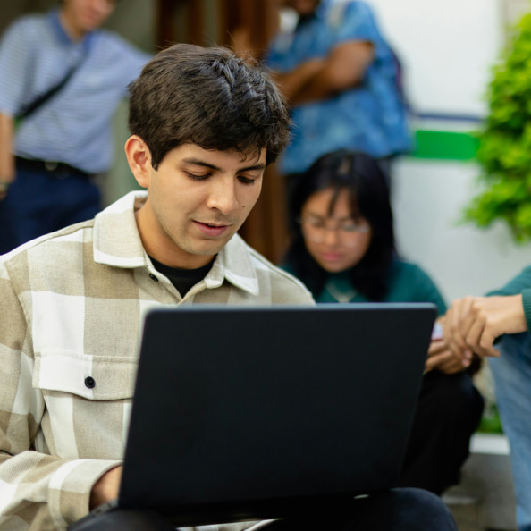 A young man with a laptop