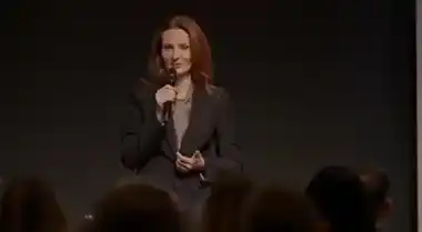 A speaker on stage, found by face recognition inside a recording