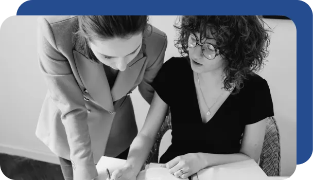 Two professionals work to figure out what they can automate with RPA.