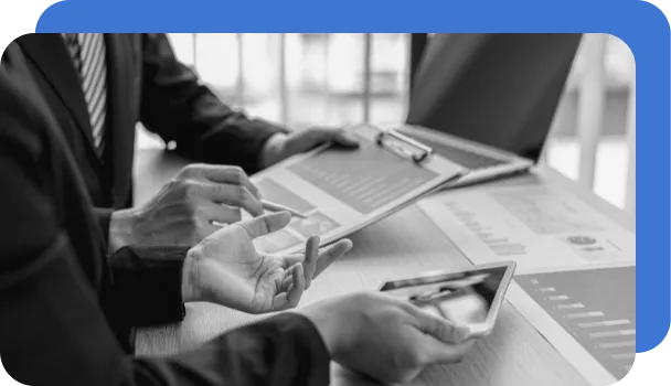 Two people review analytical charts in a financial risk management exercise.