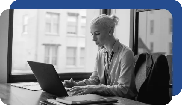 A bank worker manages risk while working on her laptop.