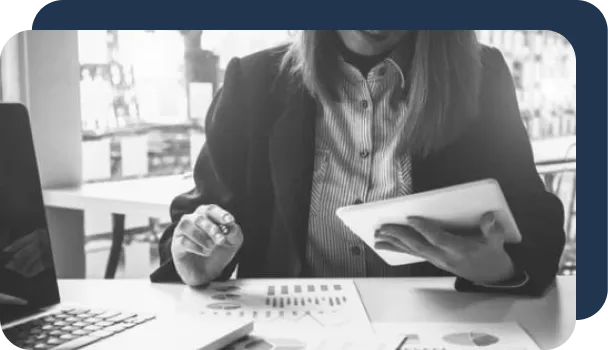 An underwriter has documents laid on a desk that she hopes to digitize using document processing.