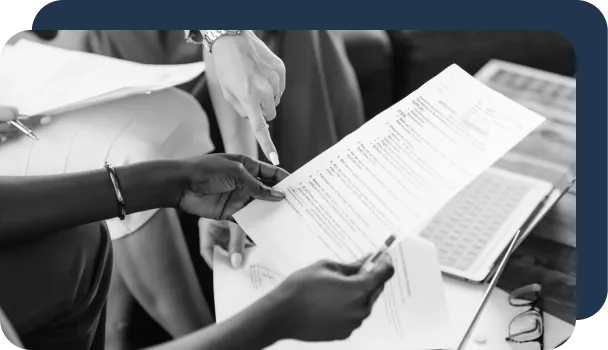 A group of people manually review documents without an IDP tool.