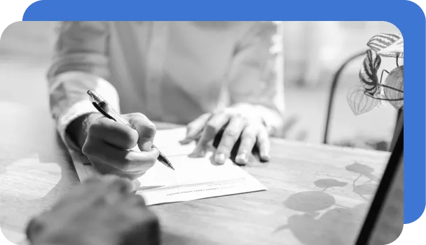 Two people review a document to detect fraud