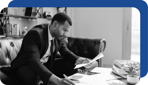 A man reviews documents for potential fraud.