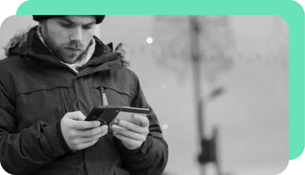 A person uses a credit card to potentially fill out a fraudulant application on their phone