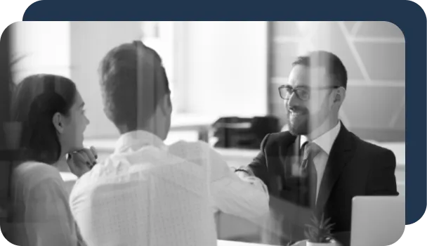 A banker sits with two potential customers in person, so he doesn't need to rely on only AI to determine whether they are fraudsters or not.