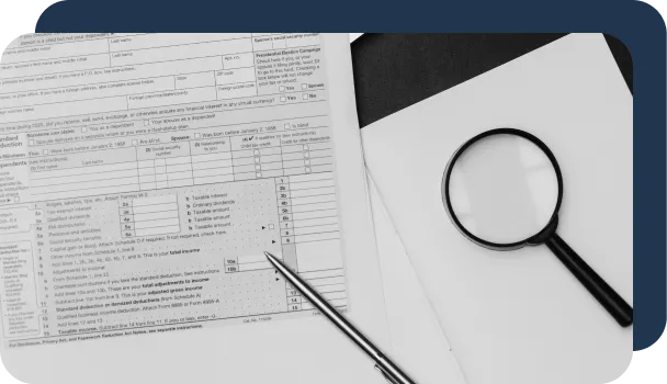 Magnifying glasses sit next to documents as if being used to detect fraud without AI.