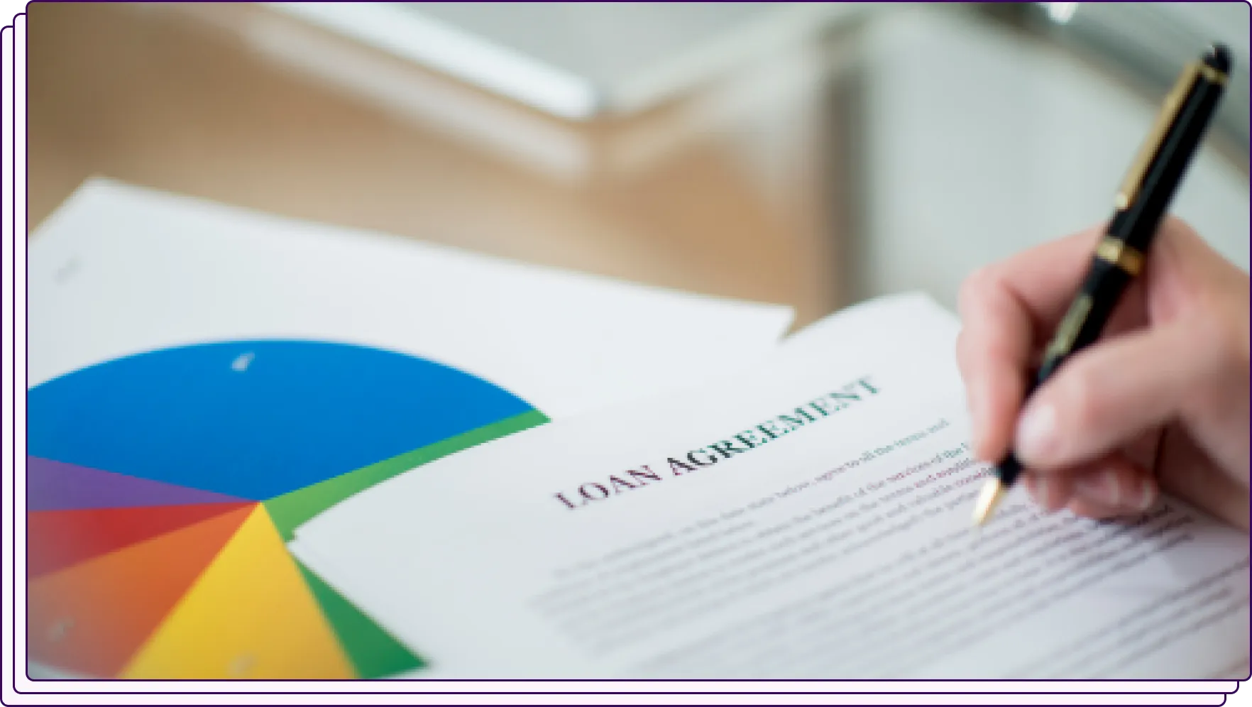 Person signing a loan agreement document with a pie chart beside it, representing final approval in the underwriting process and data-driven loan decisions.