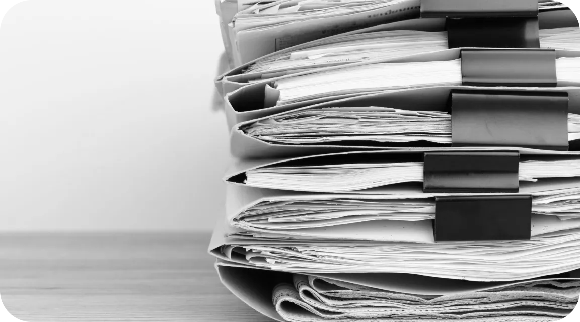 Large stack of folders filled with paper documents, illustrating the administrative burden of managing and auditing 1099 forms for tax compliance.