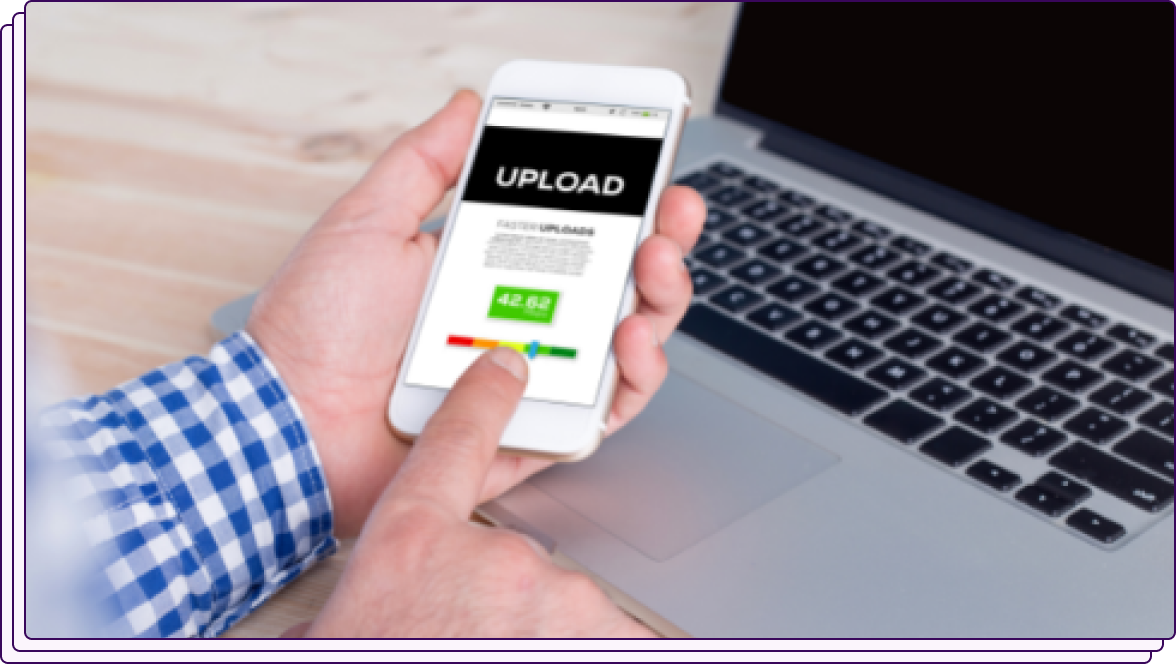 A smartphone screen displaying an upload interface with a progress bar, held by a person wearing a blue checkered shirt. The phone is placed above a laptop, symbolizing digital document uploading or file sharing.