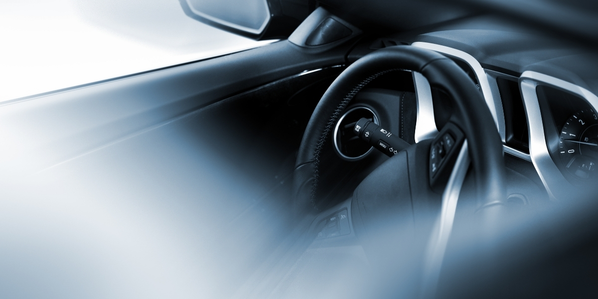 interior of a black car, steering wheel and dashboard