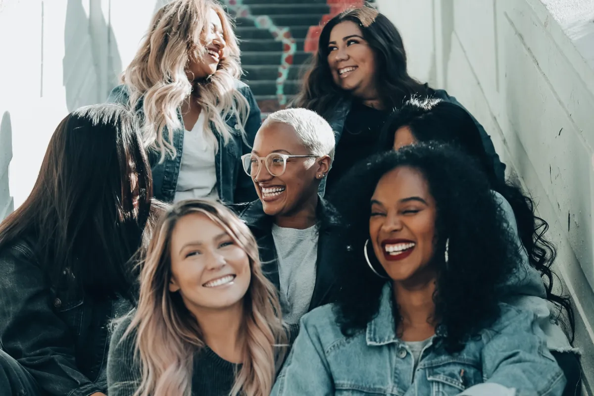 A group of people sitting and smiling