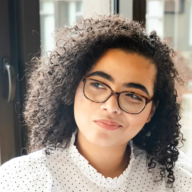 A curly-haired woman, a user of the Inflow ADHD app