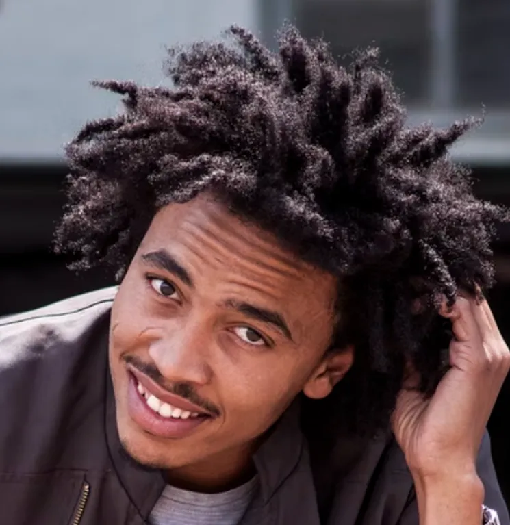 A latino man with dreadlocks An image of a user of the Inflow ADHD app. 