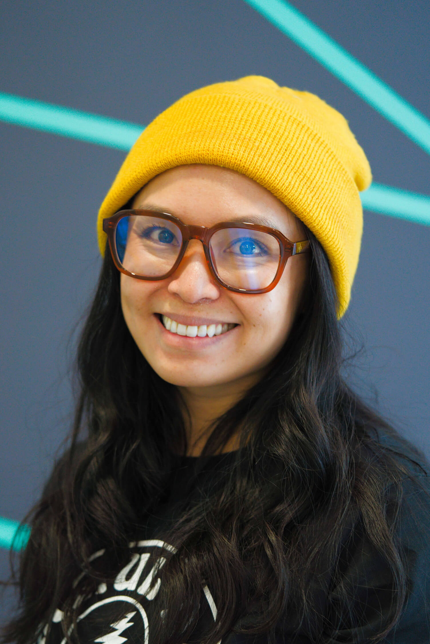 Headshot of smiling woman in yellow beanie