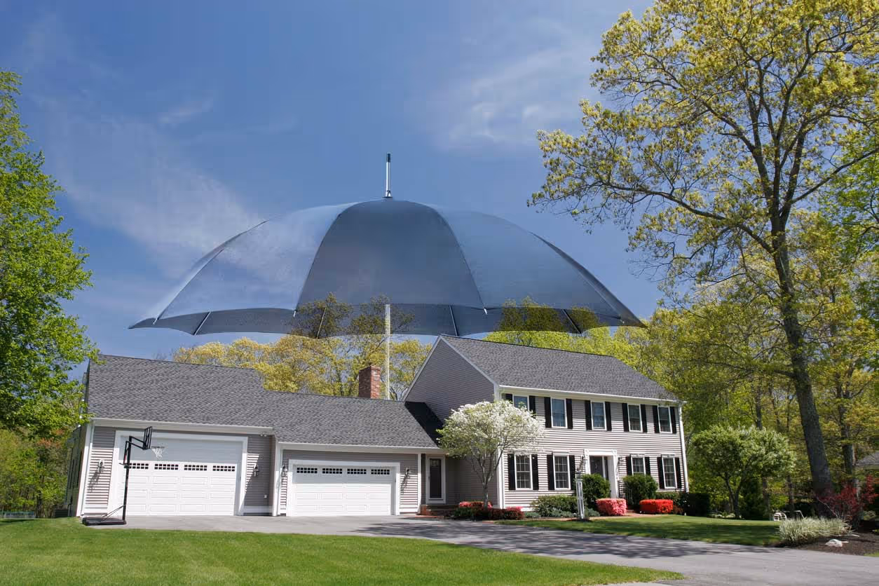 umbrella illustration over an exterior home - personal umbrella insurance concept