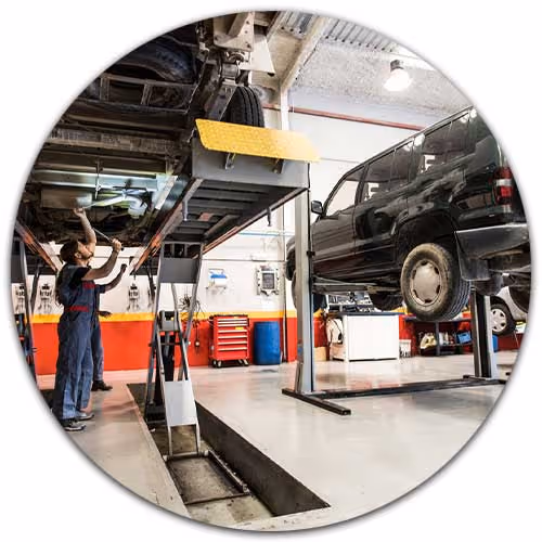 garage repair interior with cars on lifts - Garage Package Insurance concept