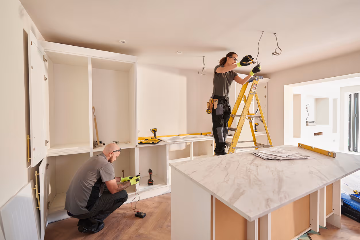 female electrician working in a kitchen remodeling