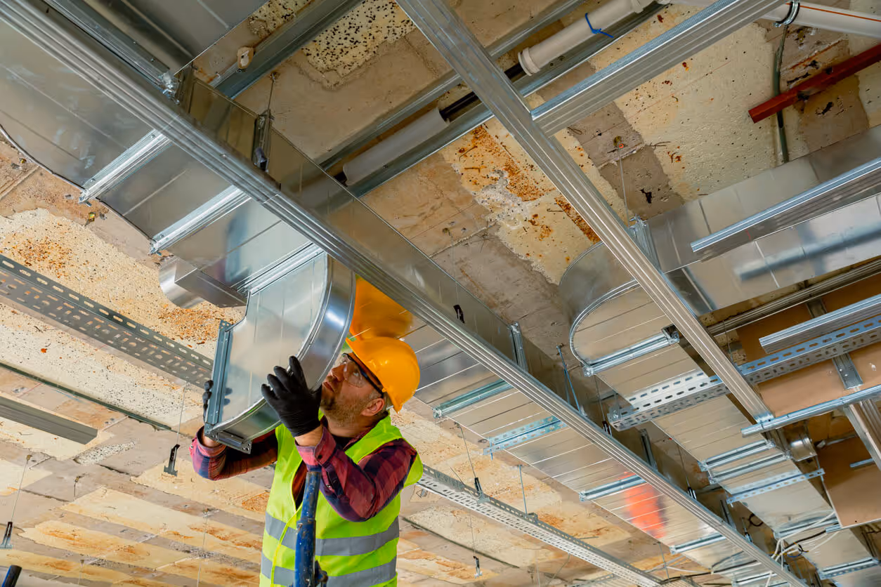 Manual Worker installing air conditioner in building