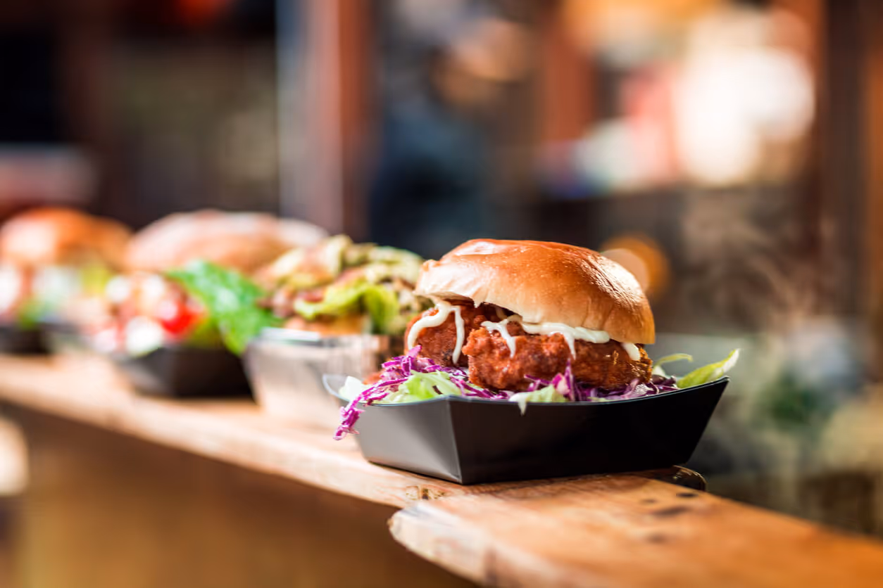 NH Commercial Restaurant Insurance concept - Fresh Crispy Pork Burgers in a row at Food Market