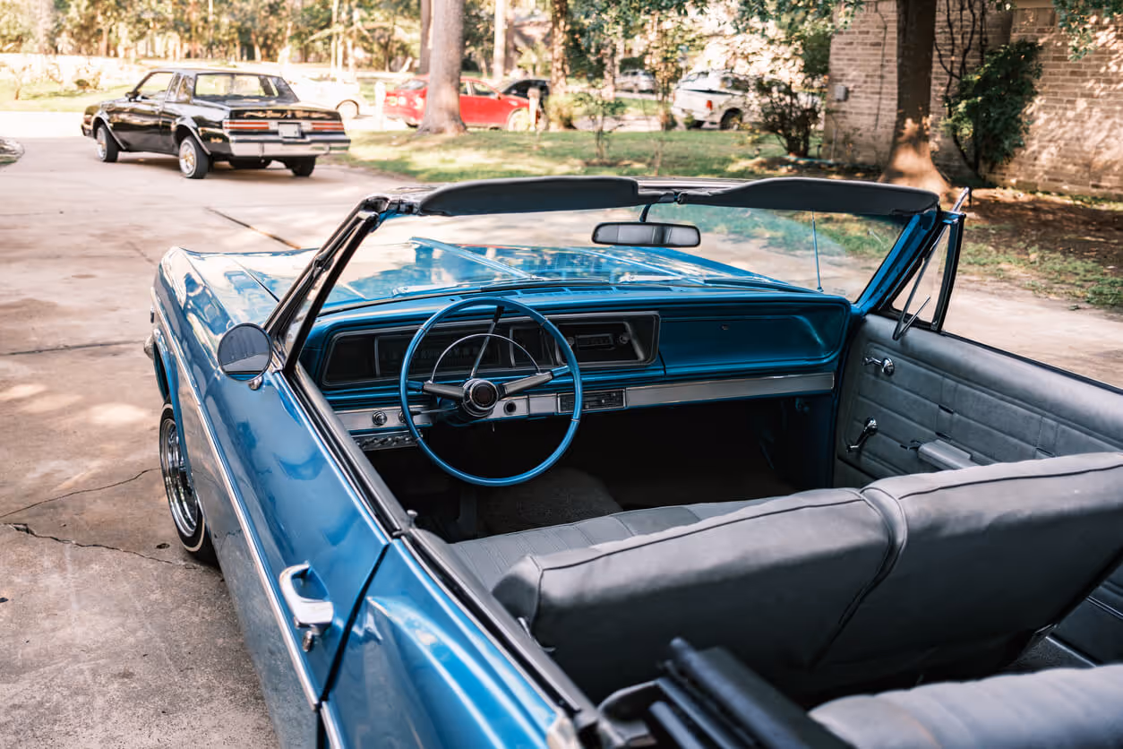 Vintage Low Rider cars parked in the driveway. exterior of private home