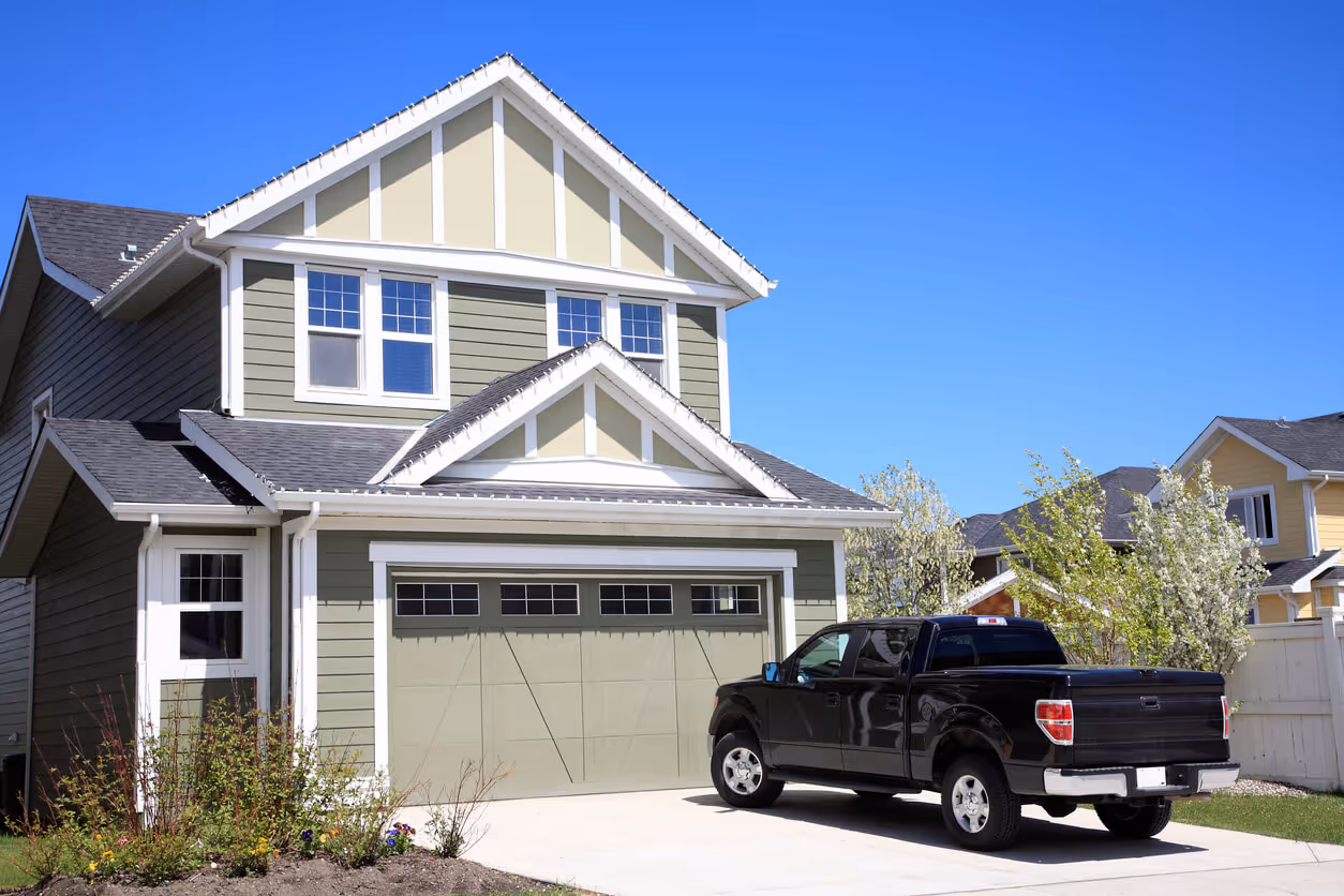 Pretty new two storey home with 4X4 truck parked in driveway