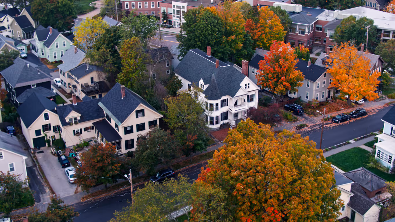 Aerial shots of houses in Concord at sunrise on a misty morning in Fall.