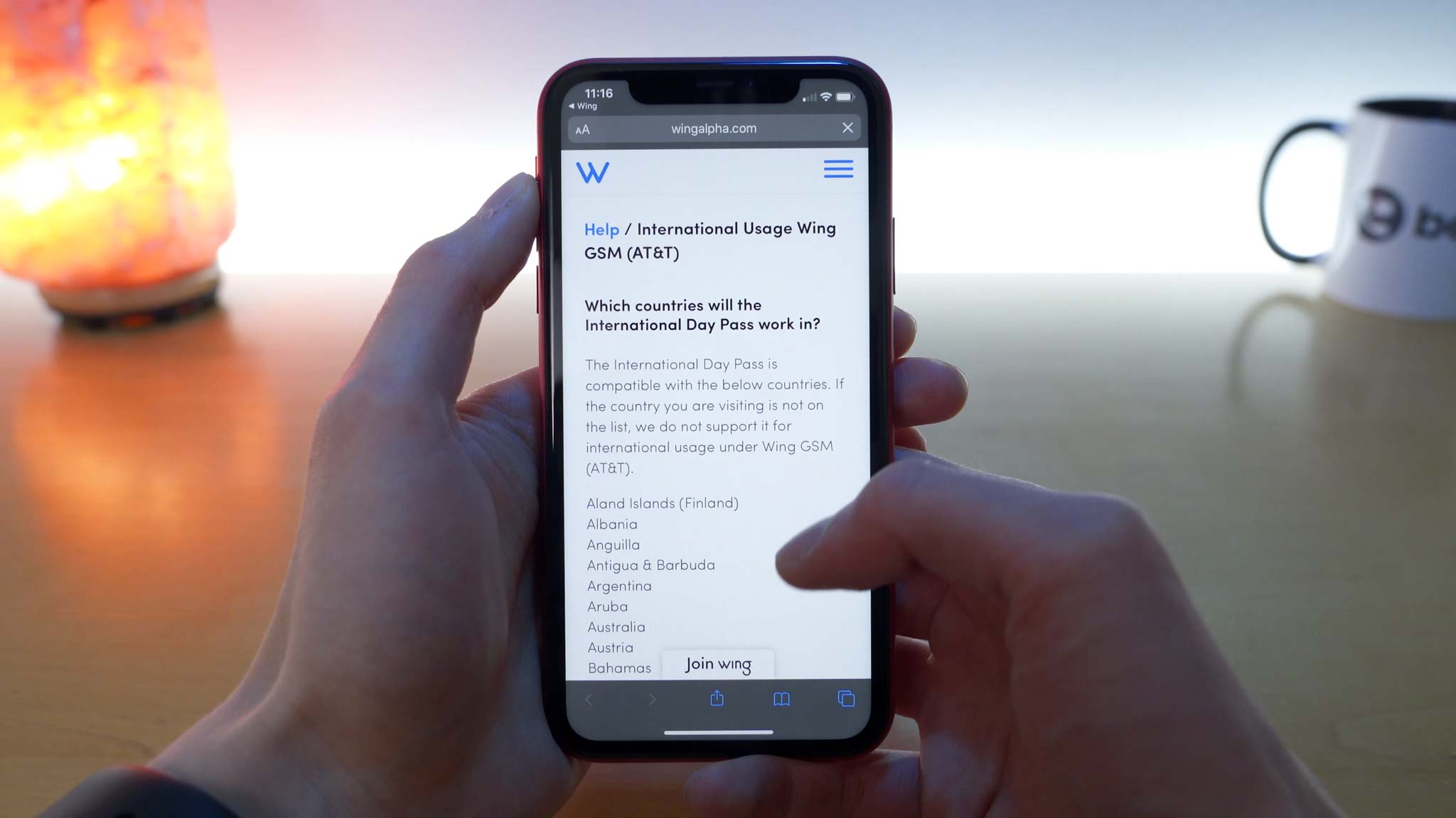 iPhone 11 Pro open to Wing website showing a list of supported international locations