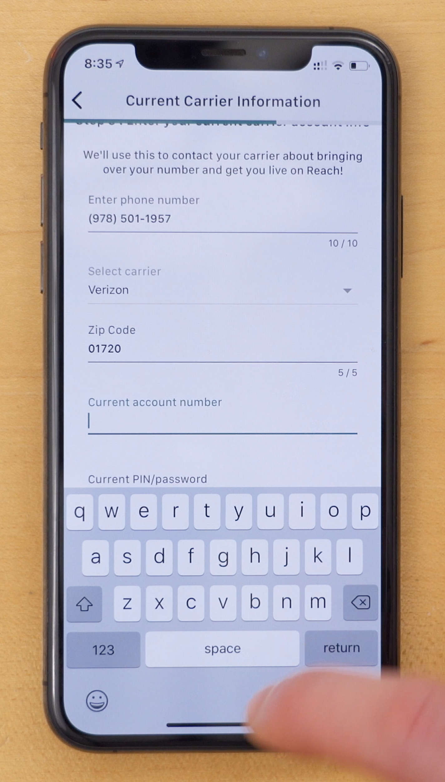 iPhone XS in Reach Mobile app on page to enter current carrier account information during activation process