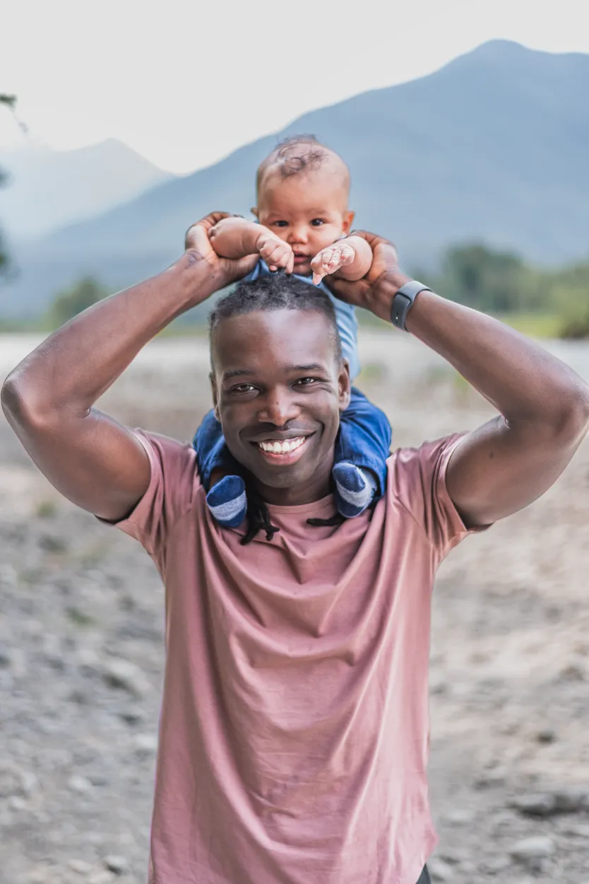 Dr. Ryan holding his baby on his head.