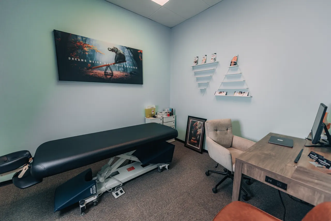 A room with a black table and a picture of a man on a bike.