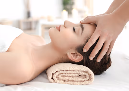 Client receiving a relaxing head and temple massage.