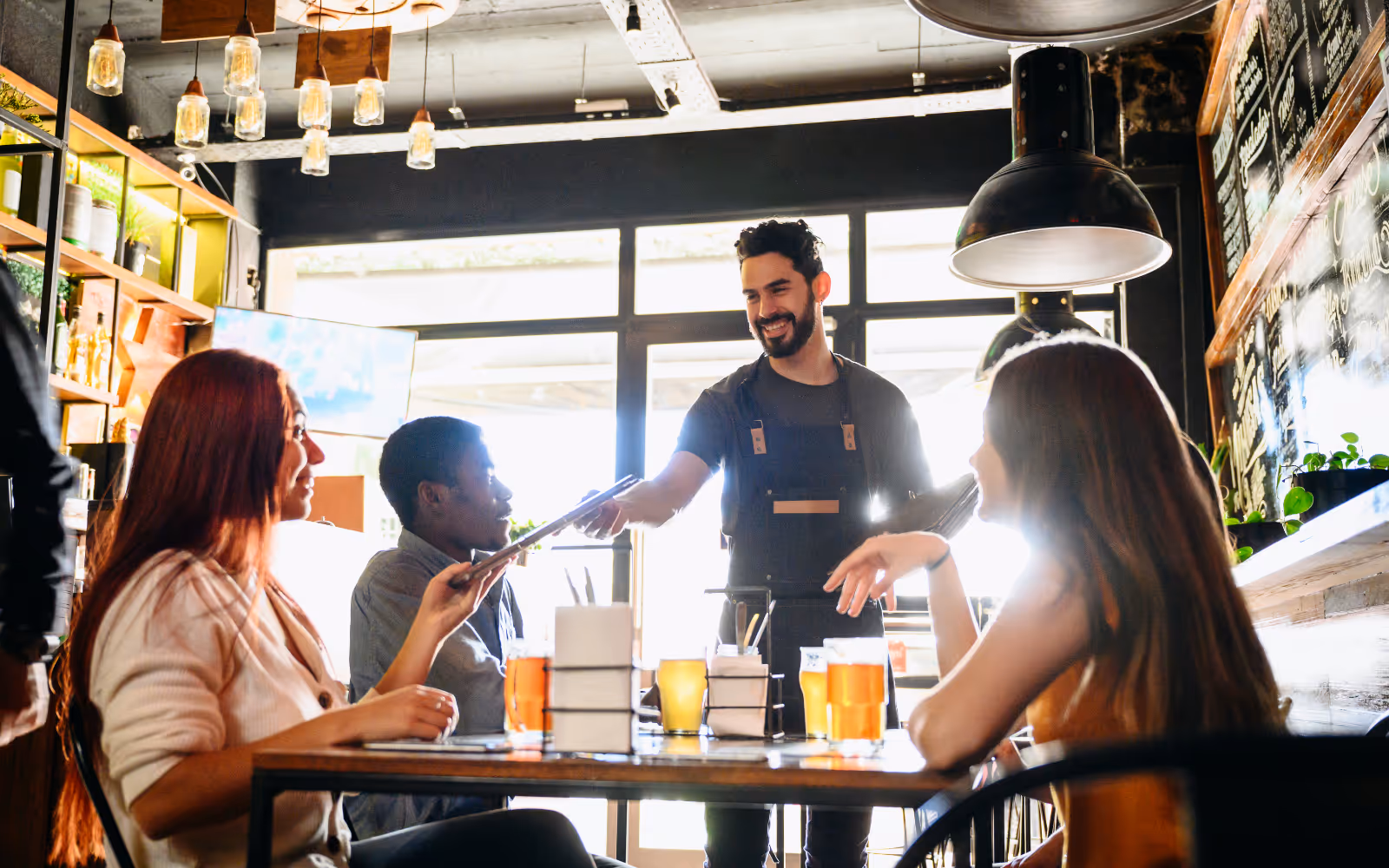 Group at a restaurant with staff member. 