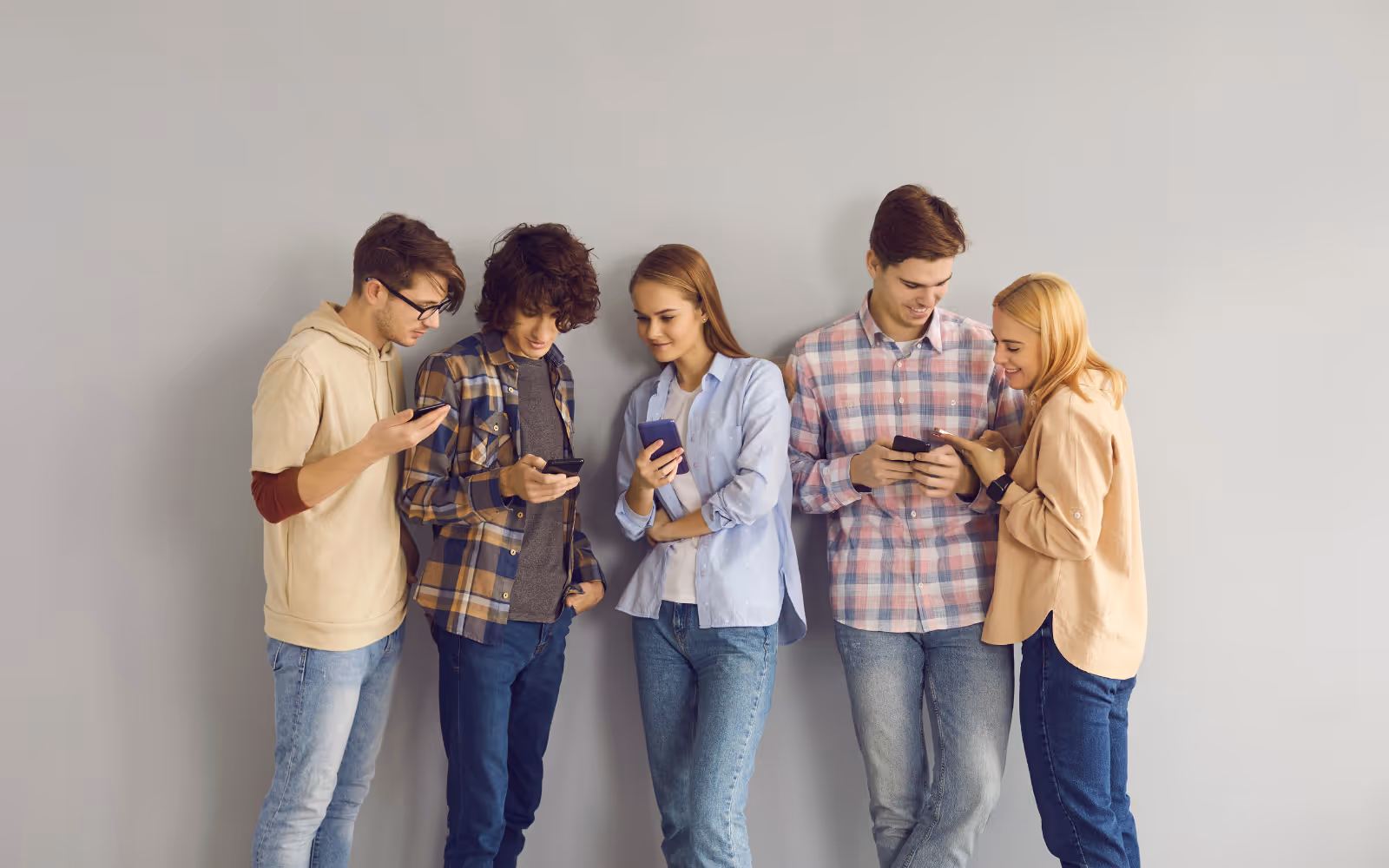 Gen z customers holding phones in a line.