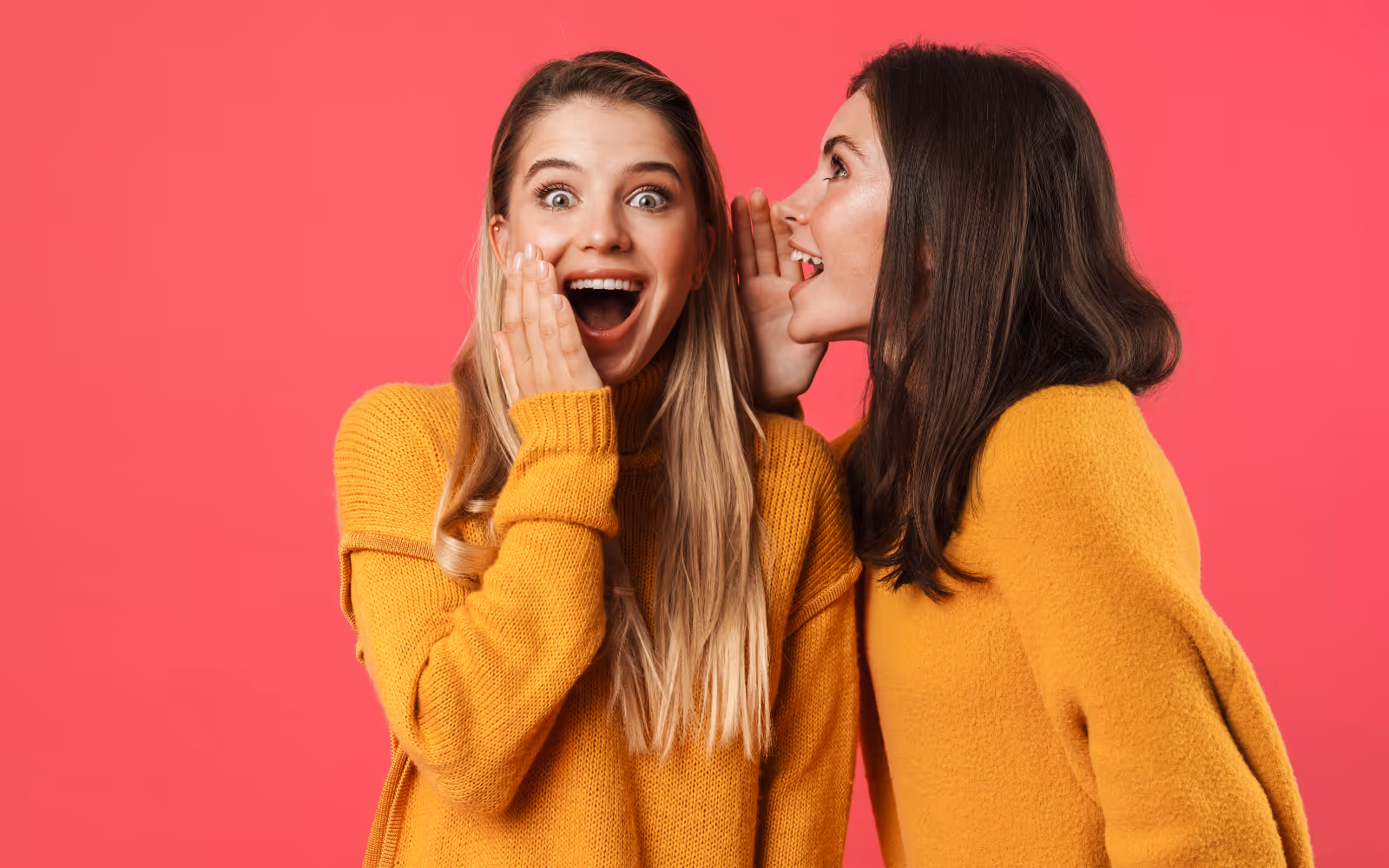 One person whispering to another person, who looks surprised, with a pink background.
