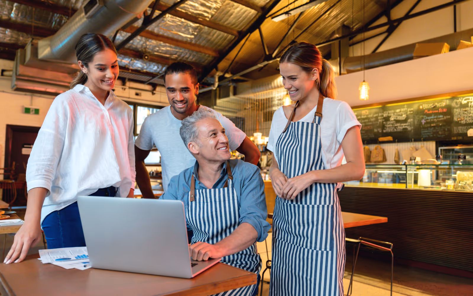 a business owner talking to his staff in a restaurant 