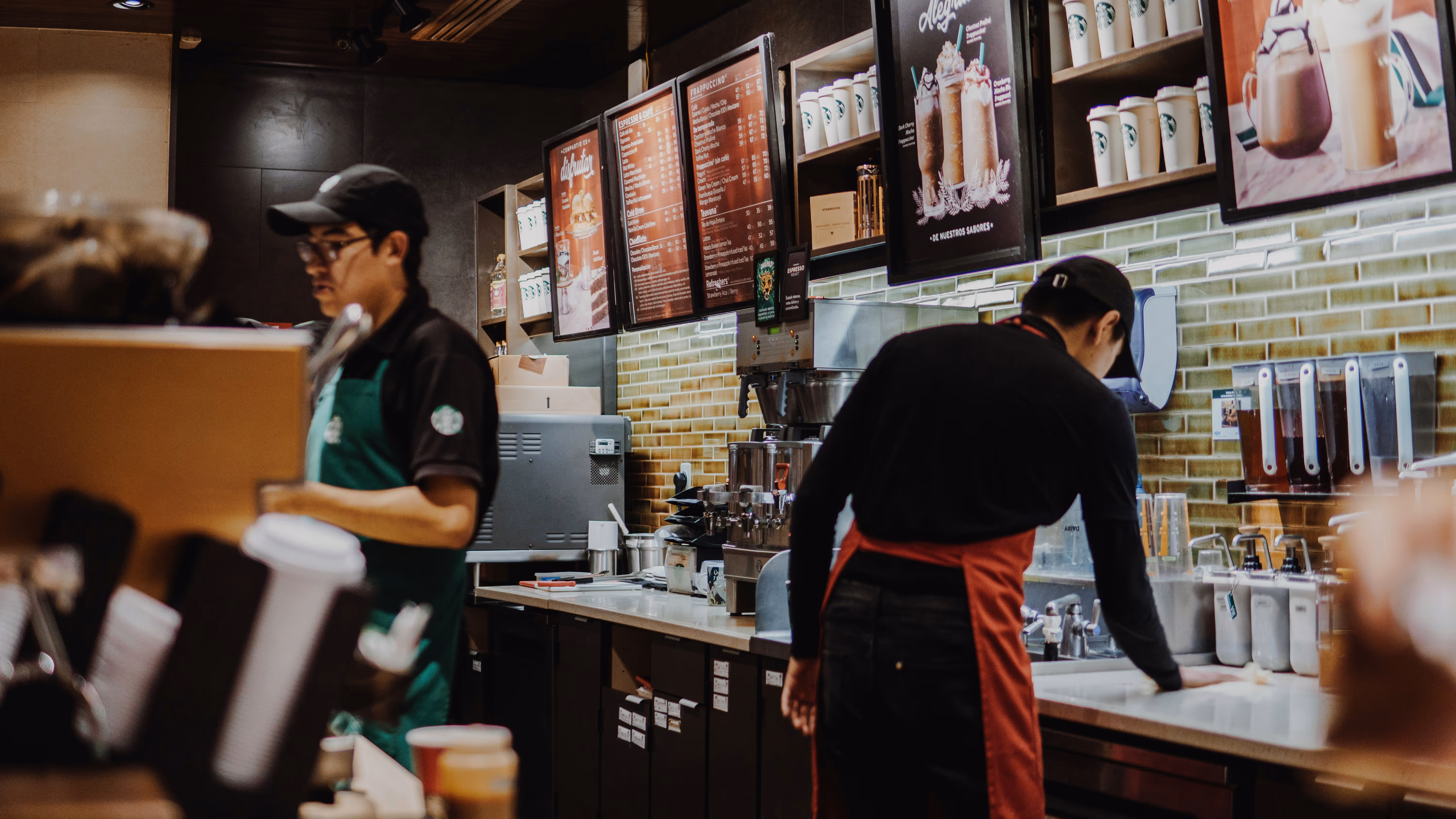 Starbucks interior with two staff members.