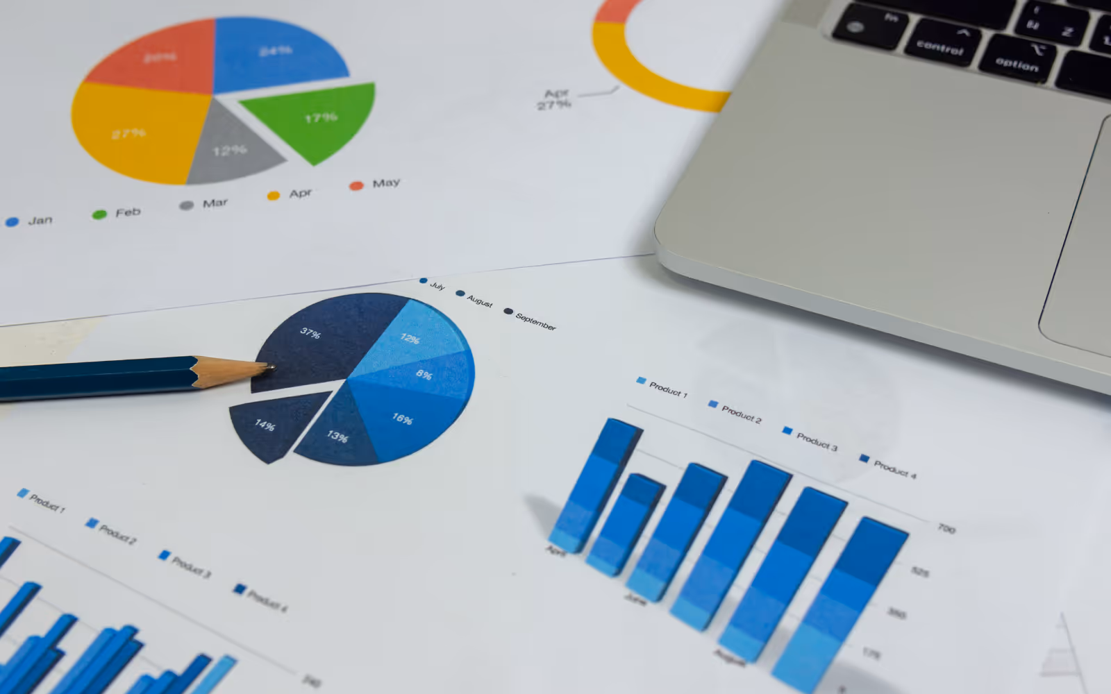 Graphs and stats open over a laptop. 