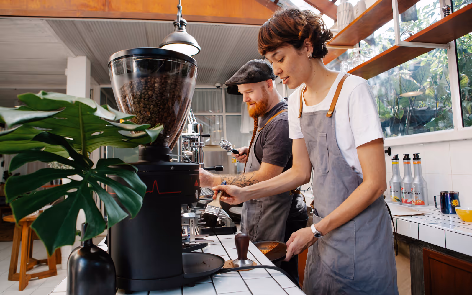 Cafe interior with two baristas