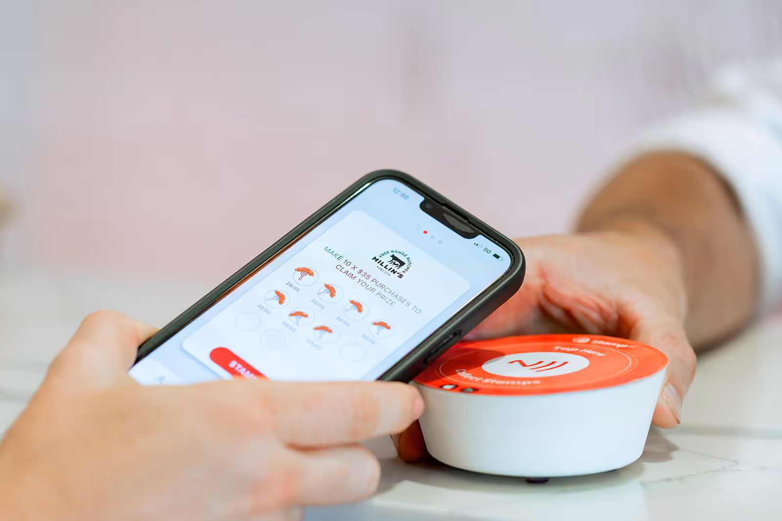 Butcher staff using Stamp Me’s StampPod to validate a digital punch card.