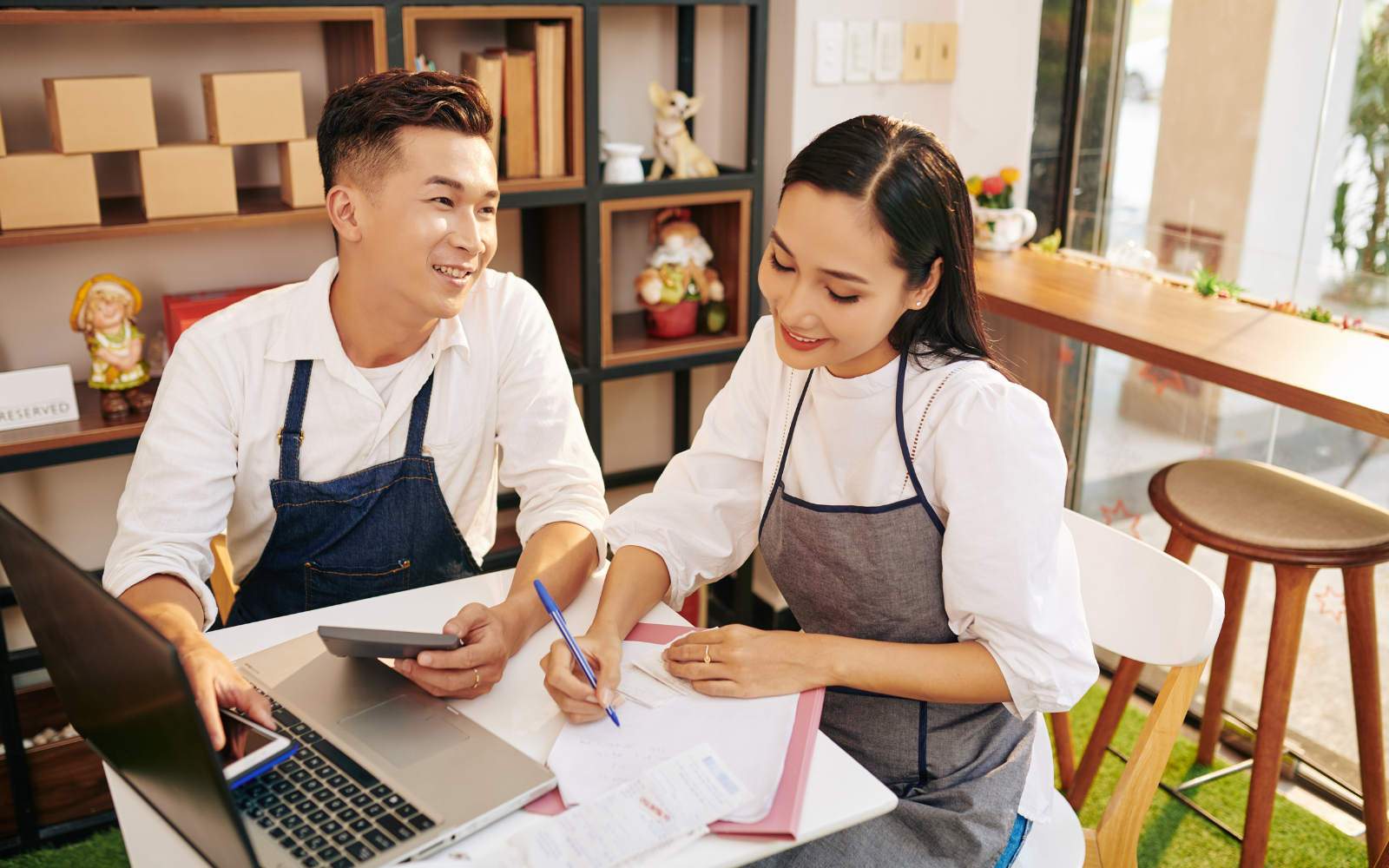 Small business owner using a laptop to manage their loyalty program online.