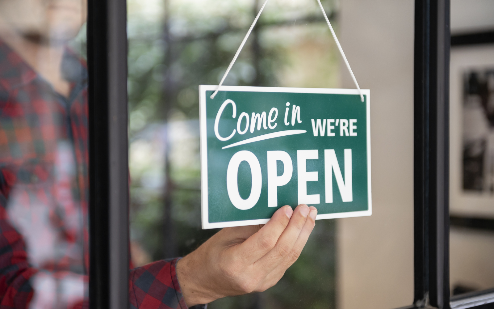Open sign displayed in a restaurant window, signaling that the business is ready to serve customers.