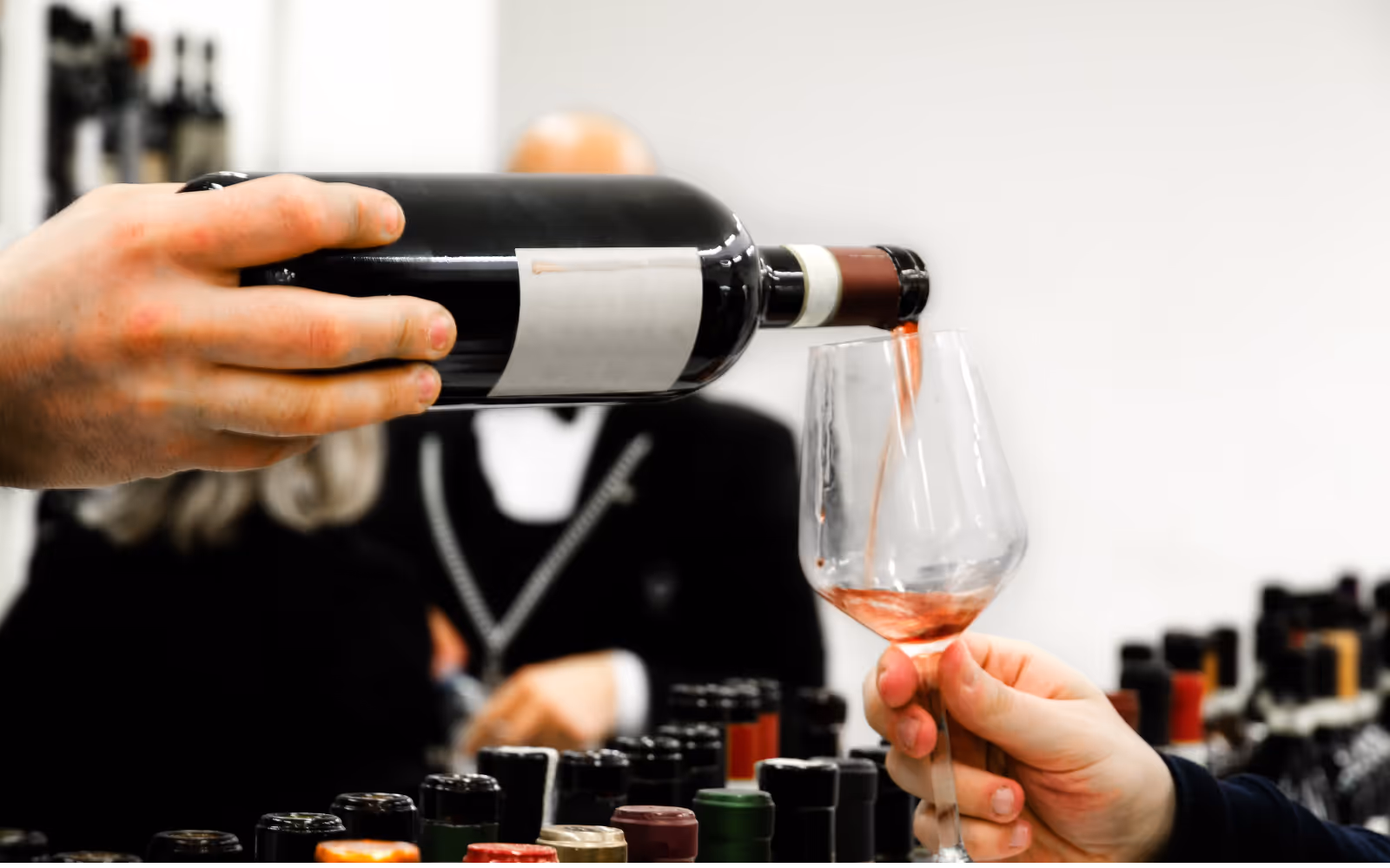 Wine tasting event at a restaurant with guests sampling different wines and enjoying food pairings.