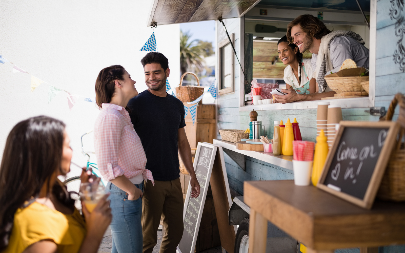Food truck with smiling customers, showcasing the impact of loyalty programs on repeat visits and customer satisfaction.