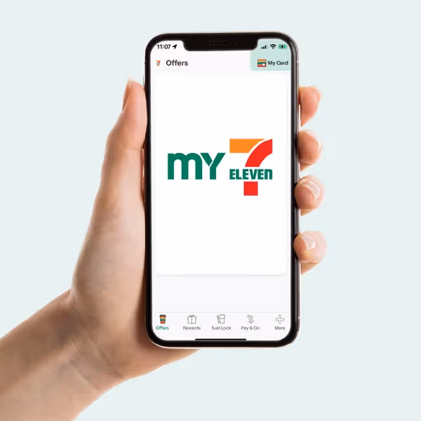 Hand holding a smartphone displaying the My 7-Eleven Rewards app in Australia