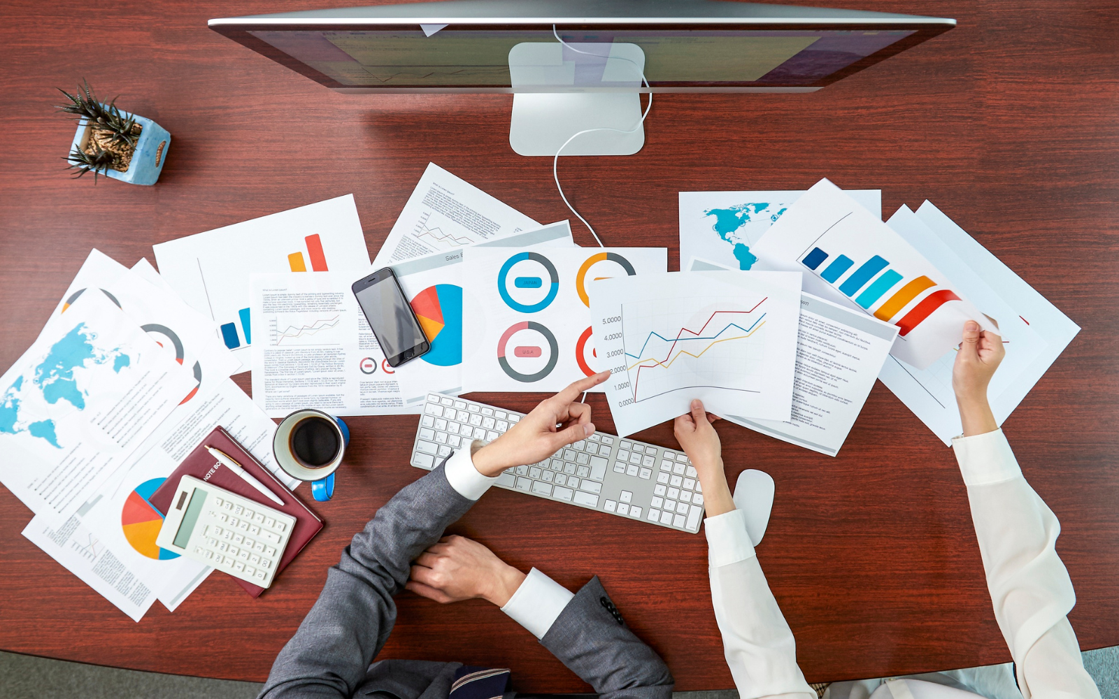 Small business owners analyzing customer loyalty programs ROI with graphs and charts showing growth and retention