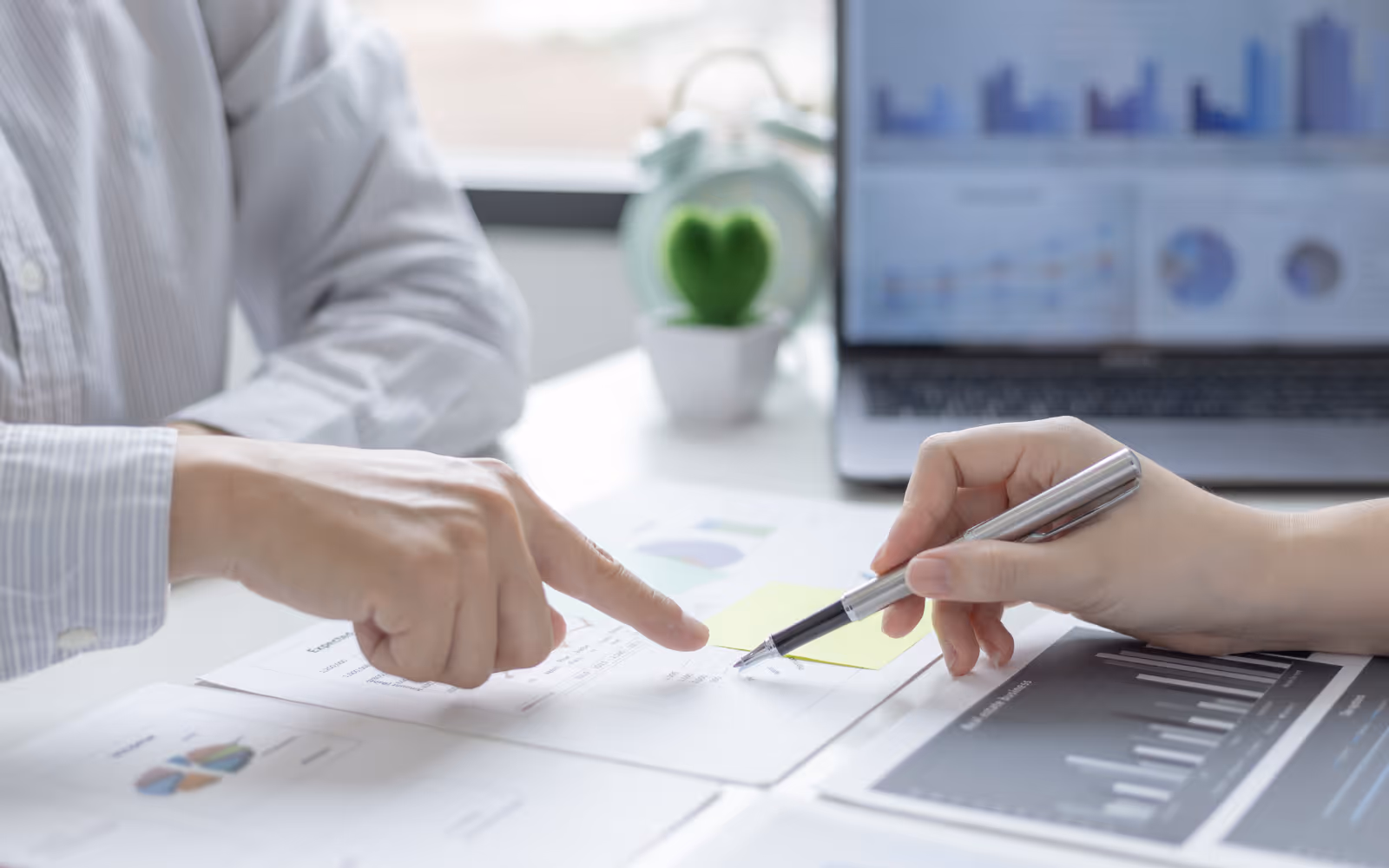 Business reviewing charts showing customer visits and reward redemptions.