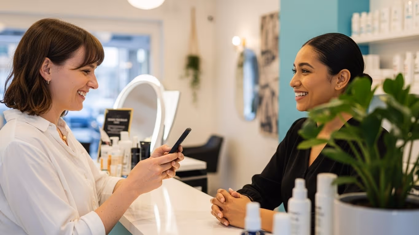 UK salon client receiving a stamp on a digital loyalty card at the checkout.